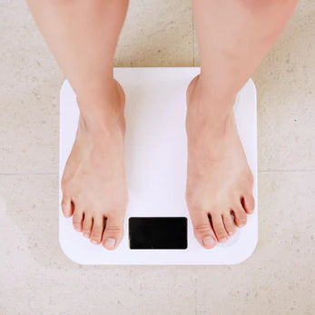 Person standing on white bathroom scales