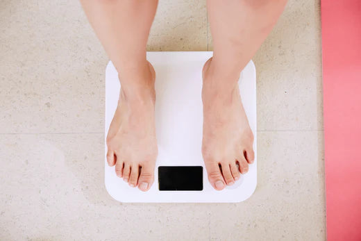 Person standing on white bathroom scales