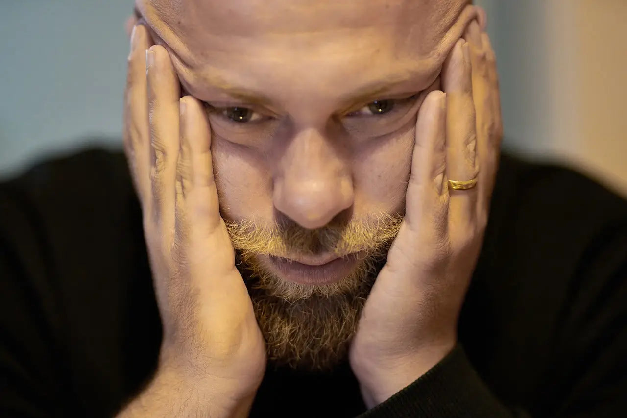Man holding his head in his hands