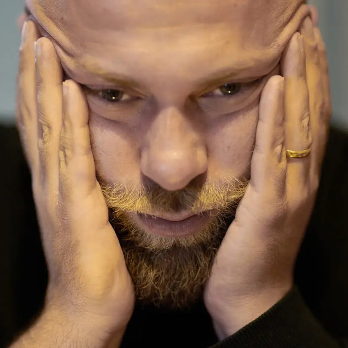 Man holding his head in his hands
