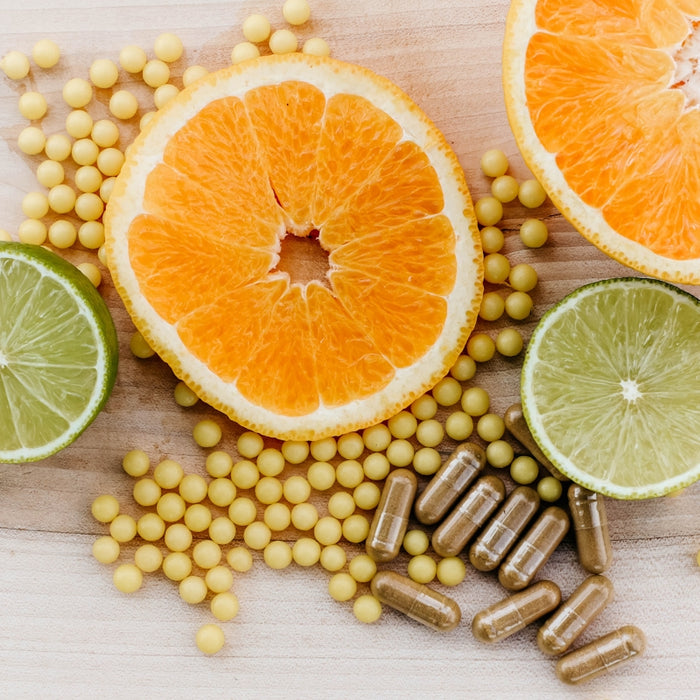 oranges, peas, and limes on a wooden table
