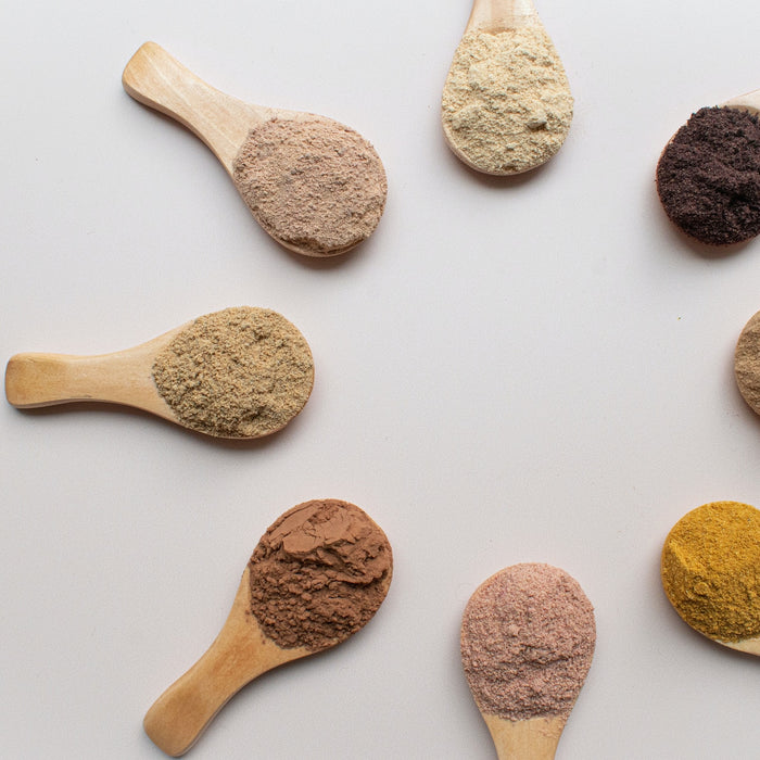 superfood powders on wooden spoons